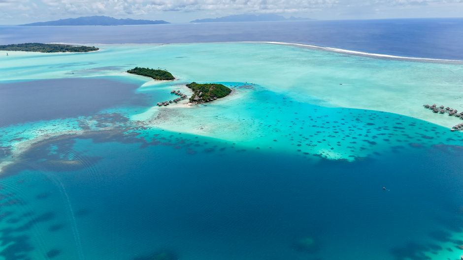 A breathtaking aerial view showcasing the turquoise waters and lush islands of Bora Bora.